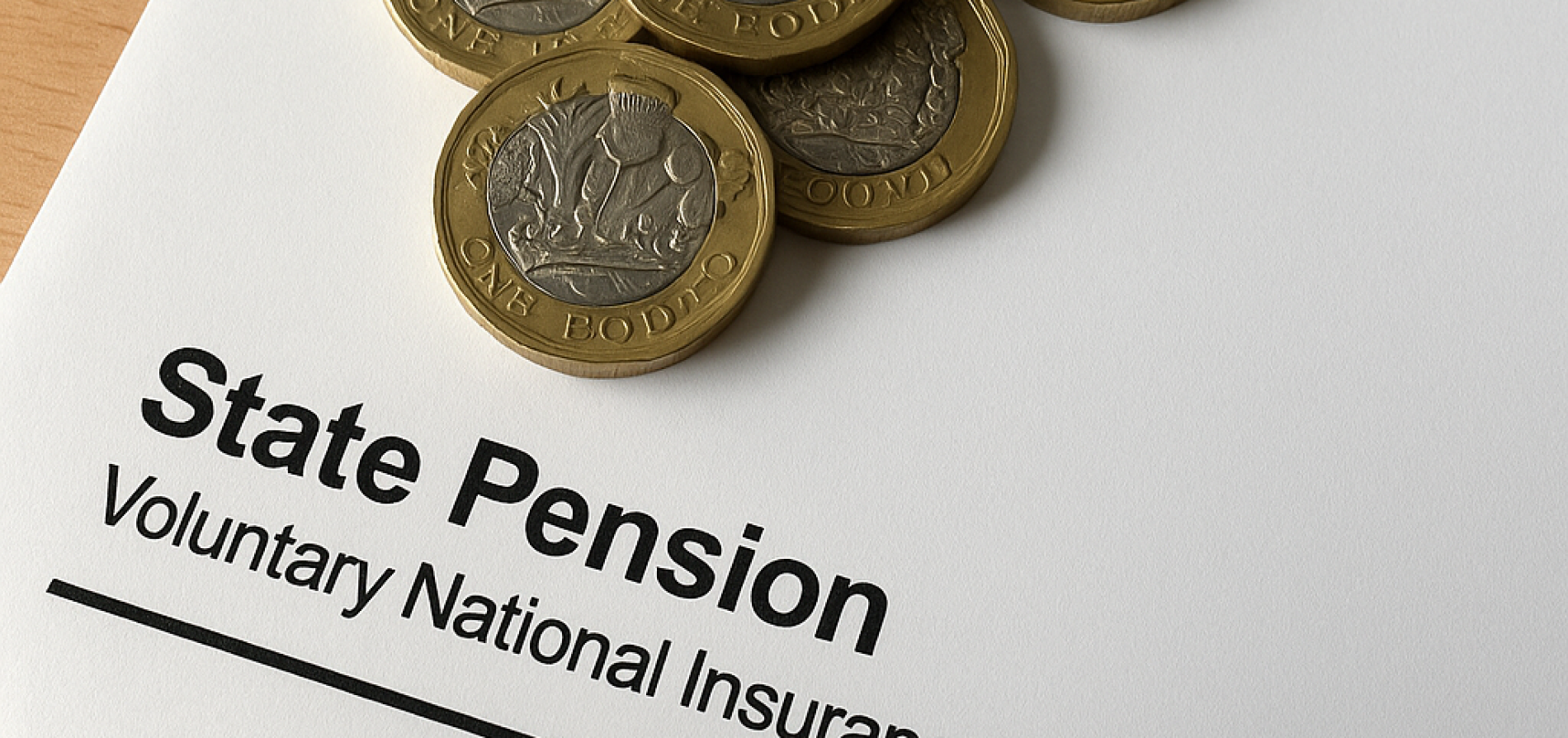 paper of state pension with penny on it