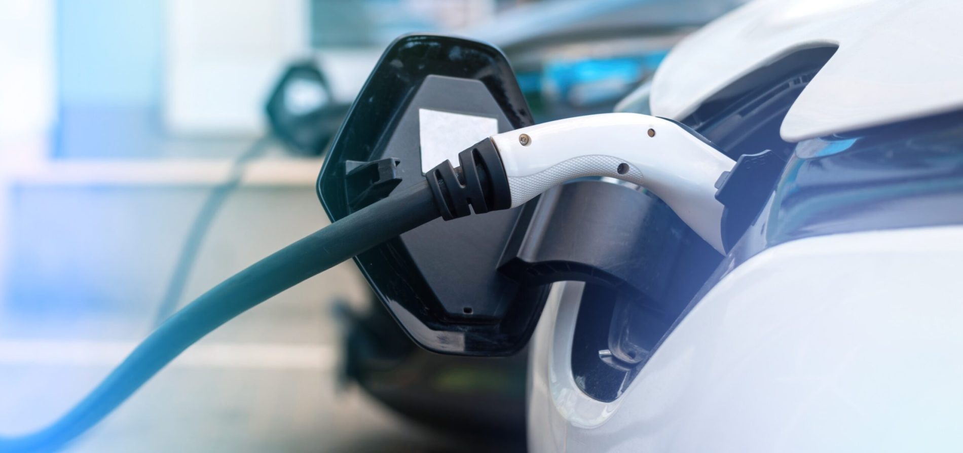 Electric car charging at a public EV charging station in the UK
